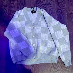 This cardigan is from cider the small business. Its pastel green with some gray.